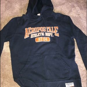 A navy blue sweatshirt with orange branding